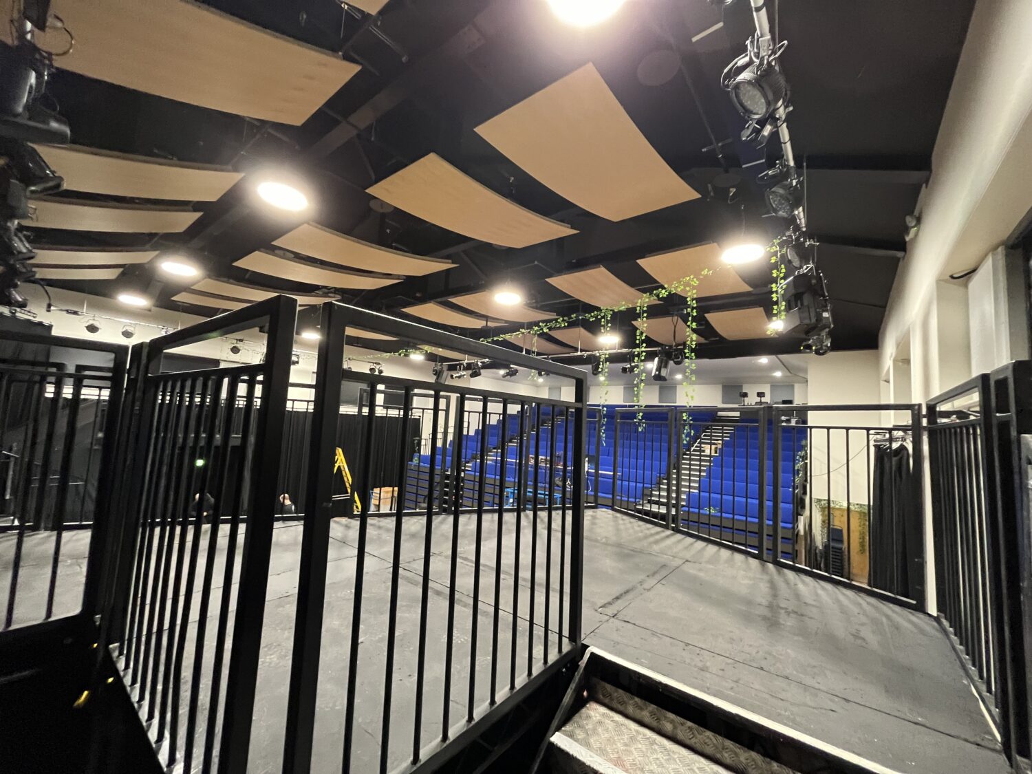 Custom multi-level Steeldeck stage with orchestra platform and castle-style balcony for school theatre production.