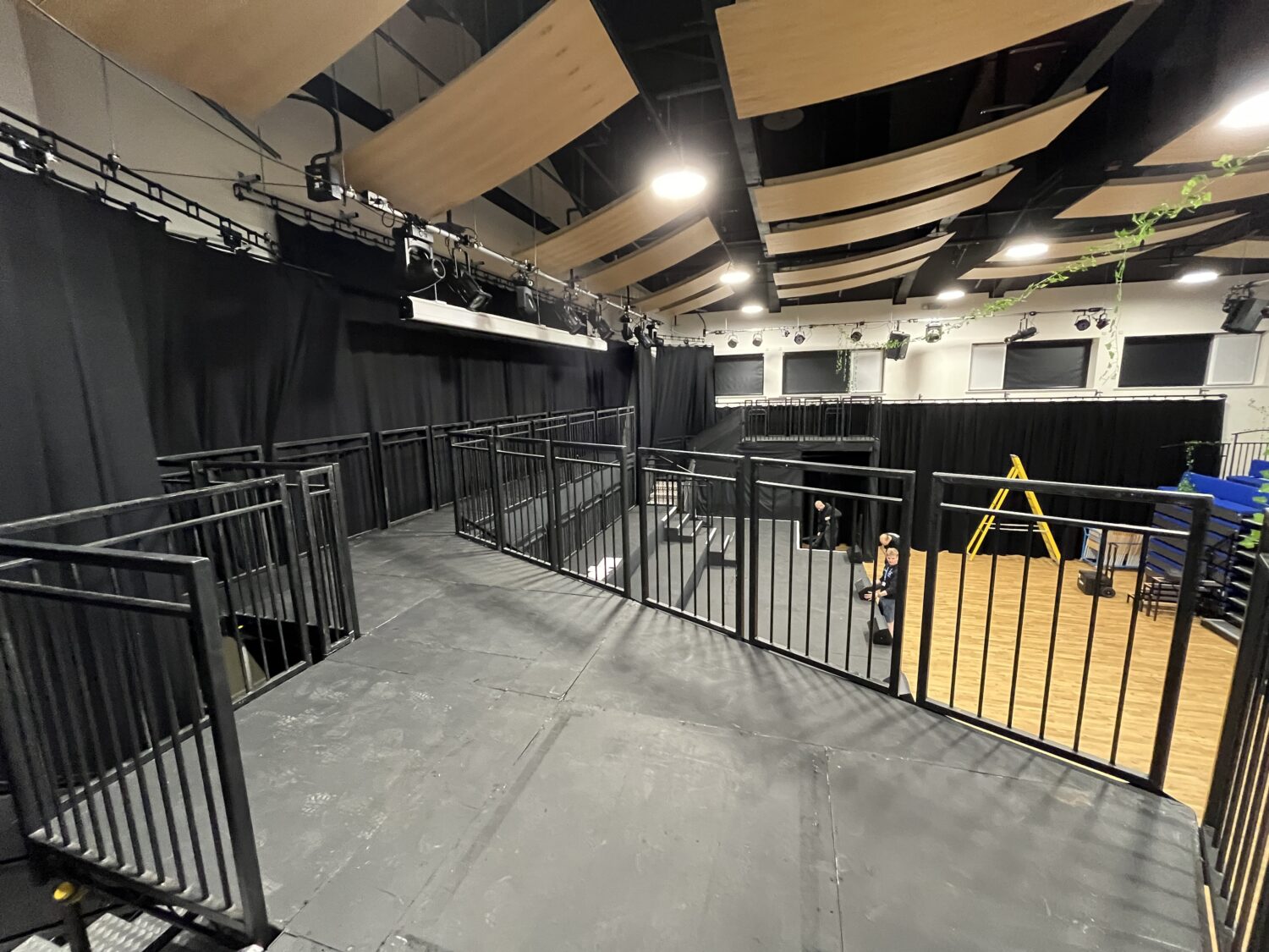 Custom multi-level Steeldeck stage with orchestra platform and castle-style balcony for school theatre production.