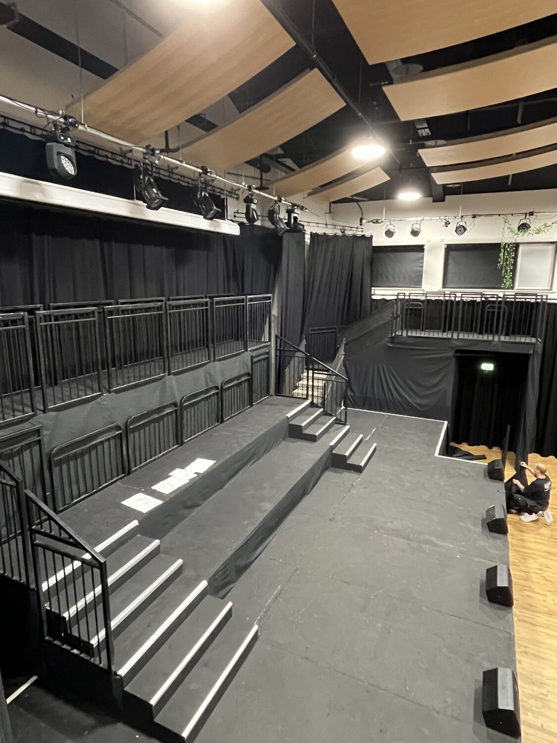 Custom multi-level Steeldeck stage with orchestra platform and castle-style balcony for school theatre production.