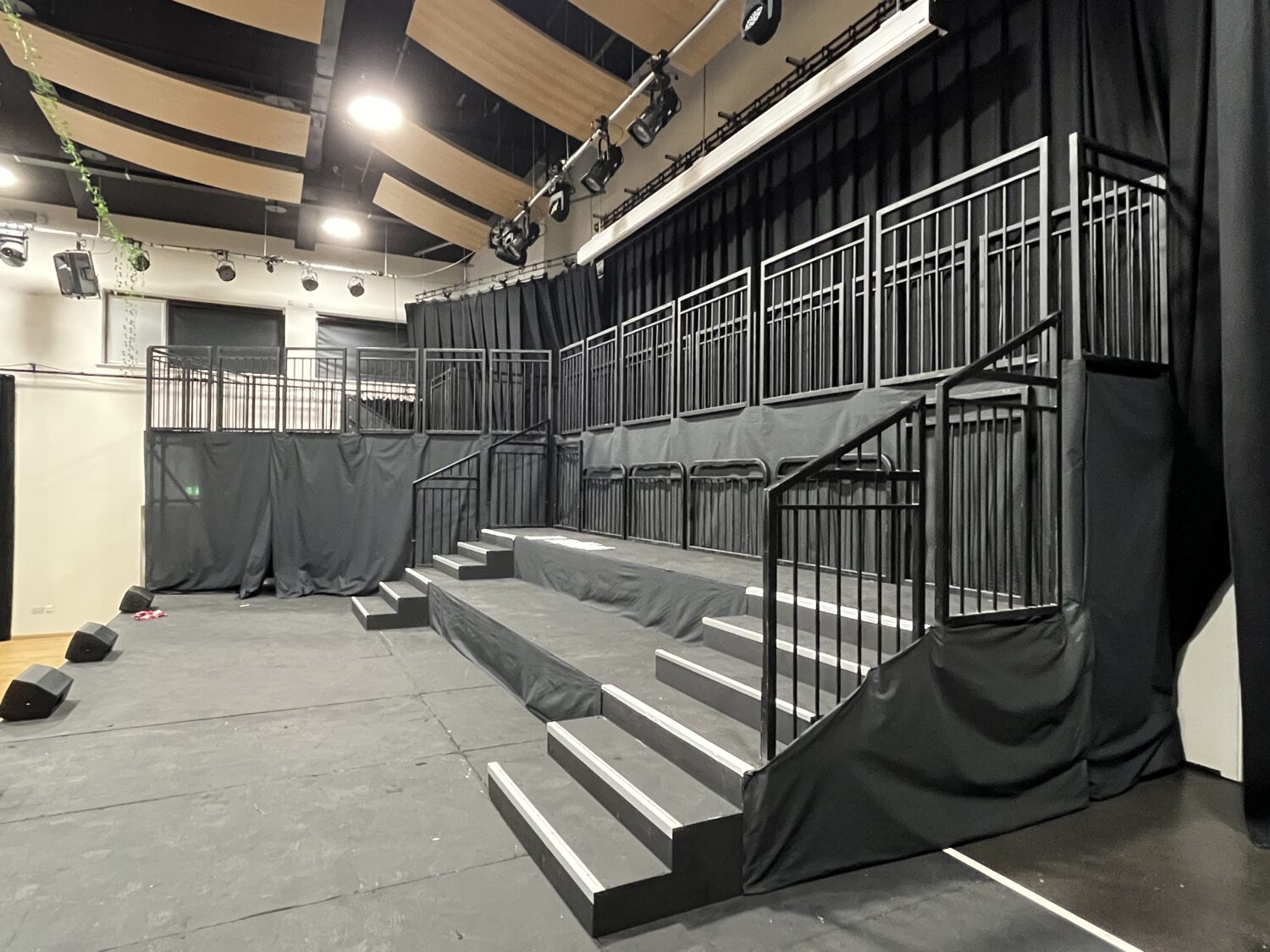 Custom multi-level Steeldeck stage with orchestra platform and castle-style balcony for school theatre production.